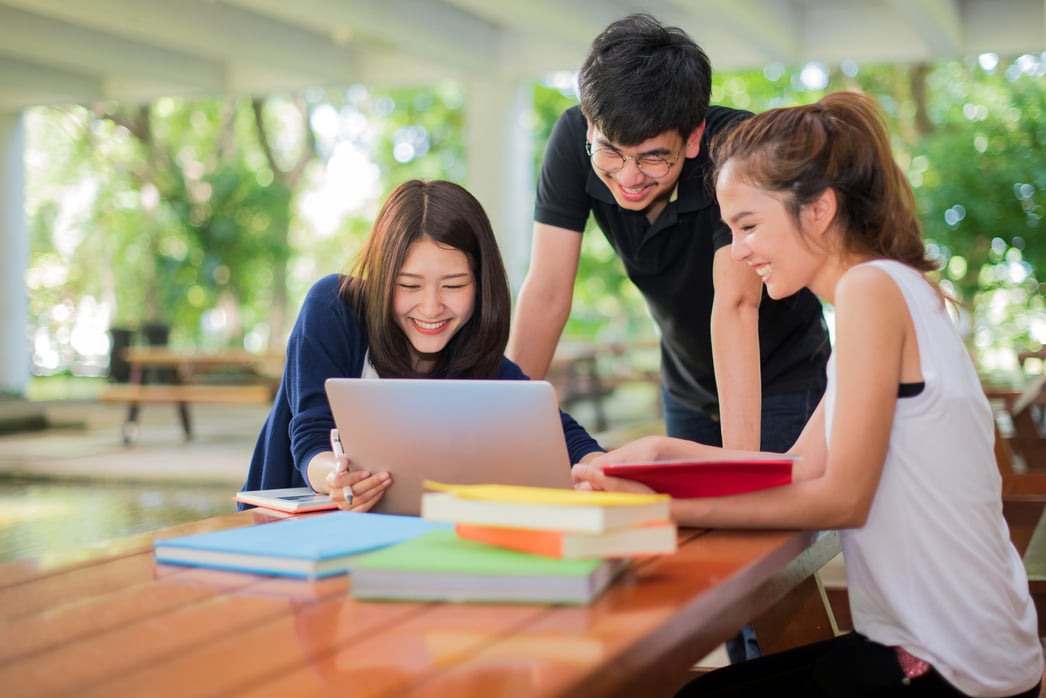 education, school and people concept - Cheerful university students with notebook; Asia university.